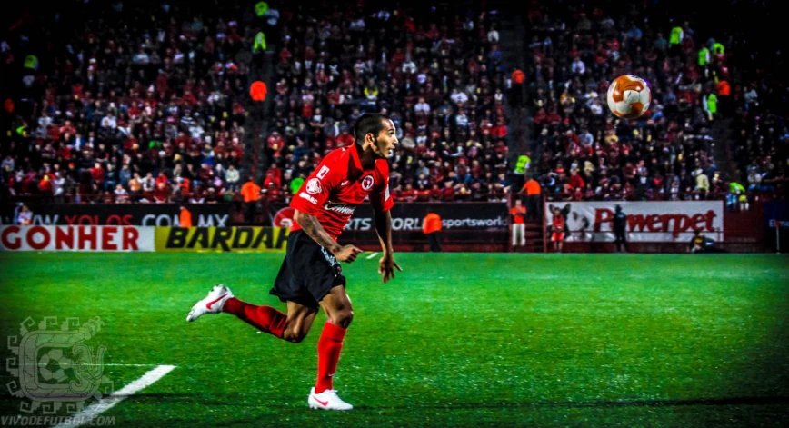 a soccer player is preparing to kick the ball