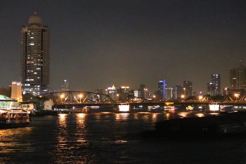 the boats are traveling along the water in front of the city skyline