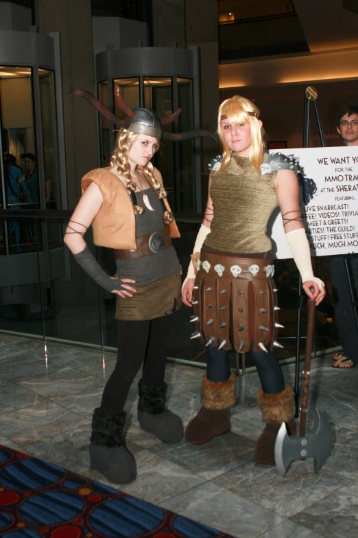 two women in costume standing on either side of a building