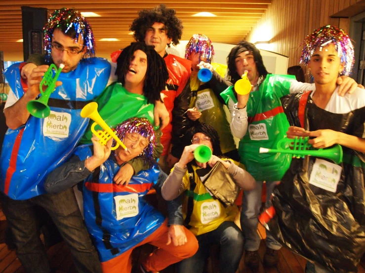 a group of people with funny outfits and balloons