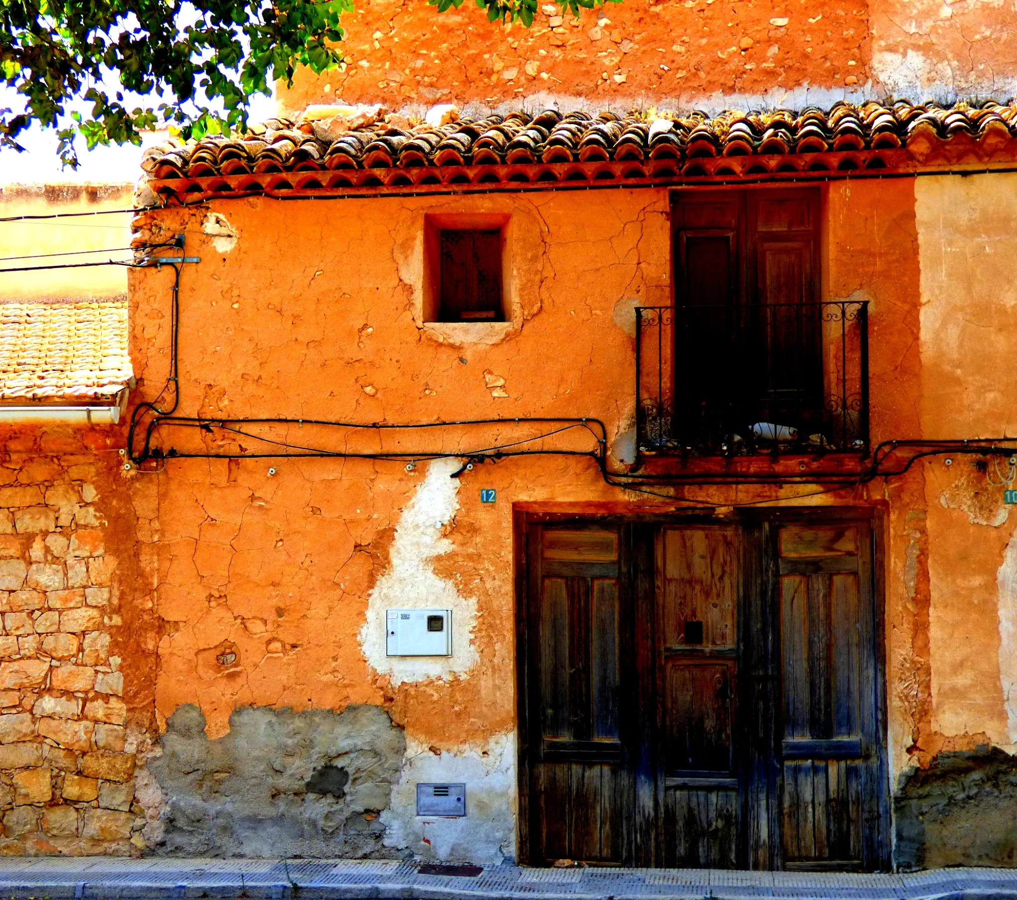 a building that is orange in color and has a wooden door