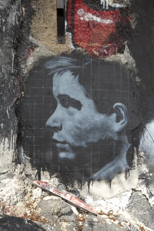 a street wall with a portrait of a man on it