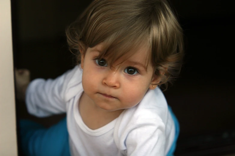 a little boy that has a white shirt on