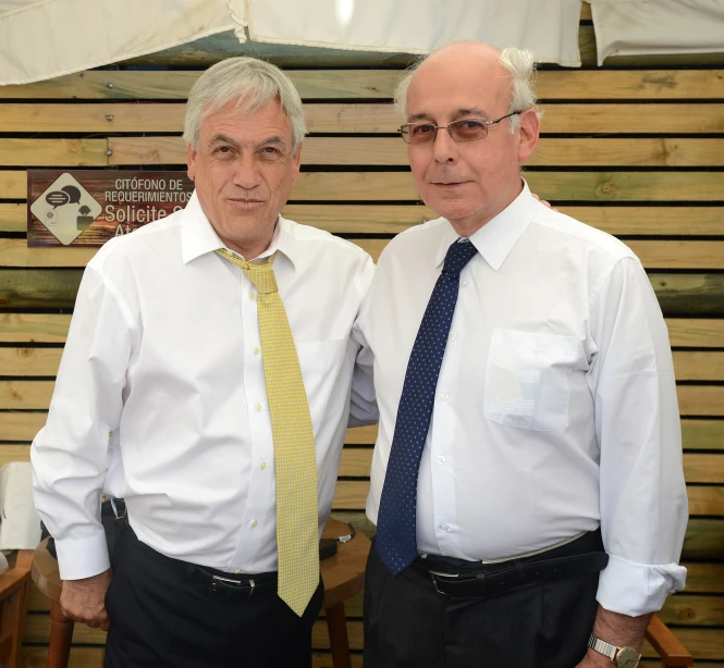 two older gentlemen in formal dress posing for a po