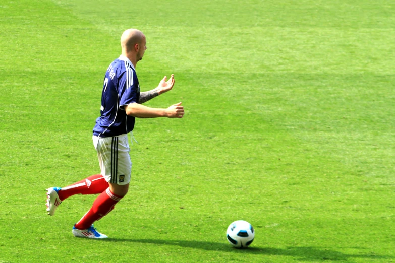 there is a male soccer player about to kick the ball