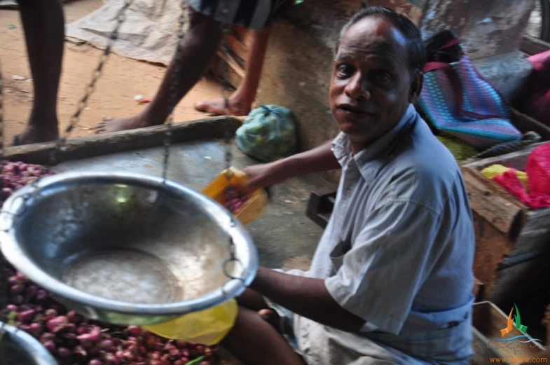 man in the process of making food item at table