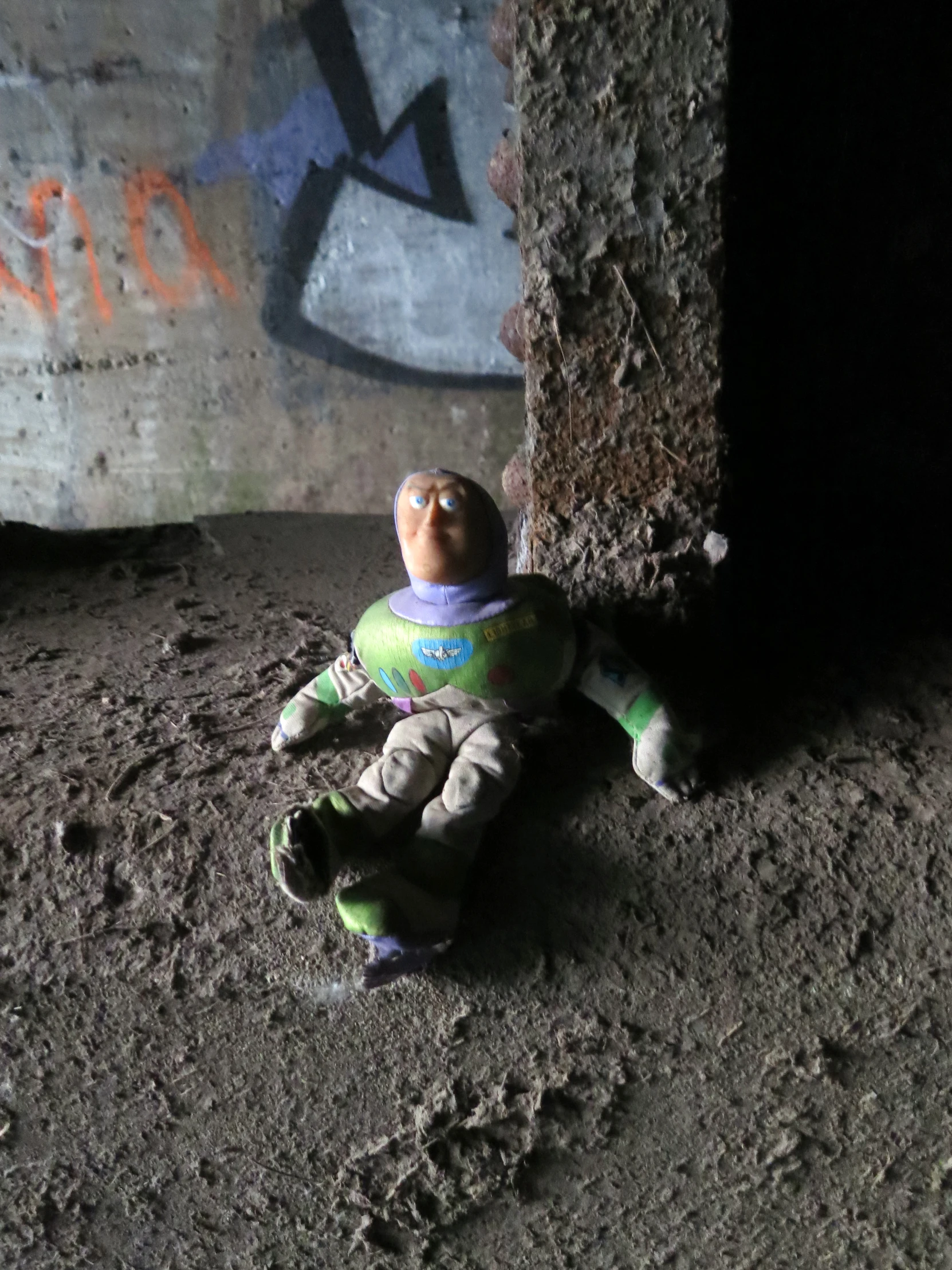 a toy laying on the ground next to a wall