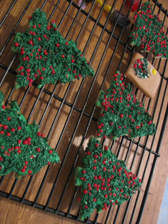 some cookies are decorated with green and red decorations