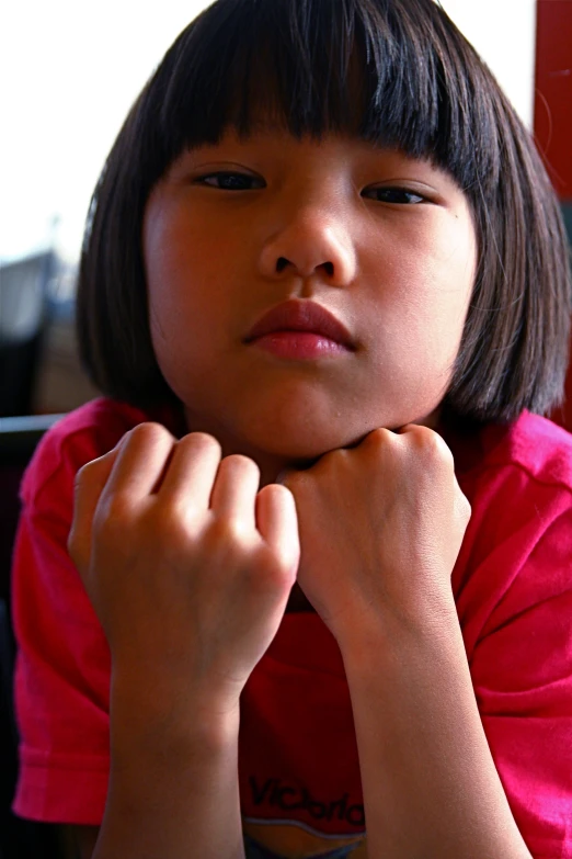 young child in pink shirt leaning over to the side