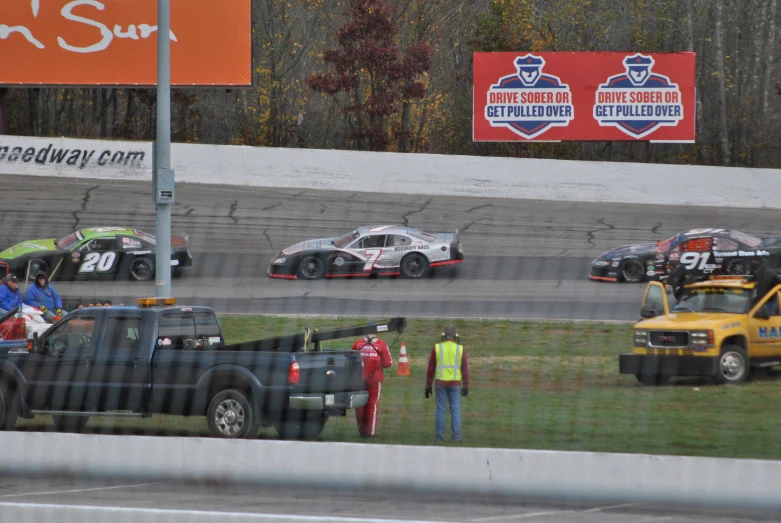 three cars passing each other on the race track