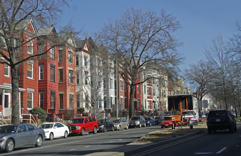 many cars parked on the side of a road