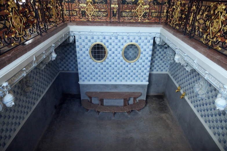 a room with a bench and a decorated wall