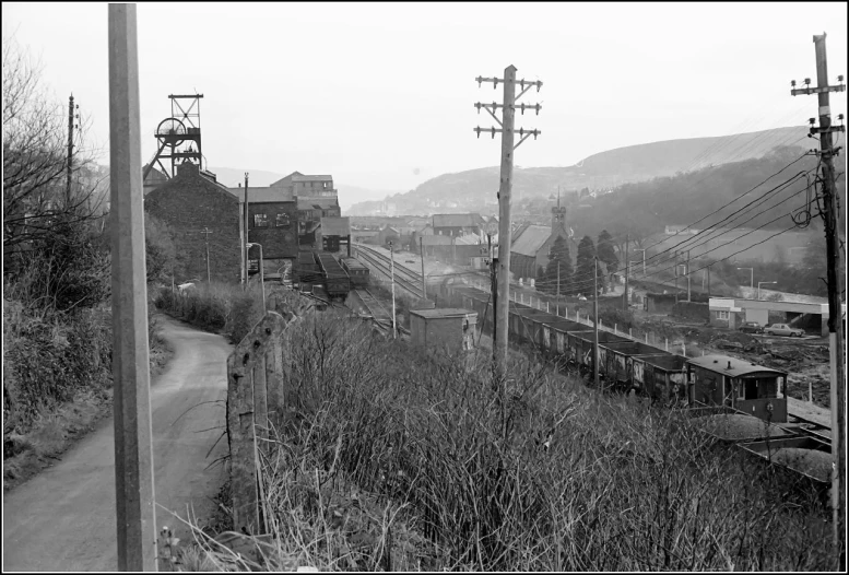 an old railroad and train yard with the sky on gray