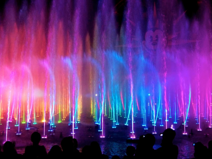 a group of people standing around a fountain