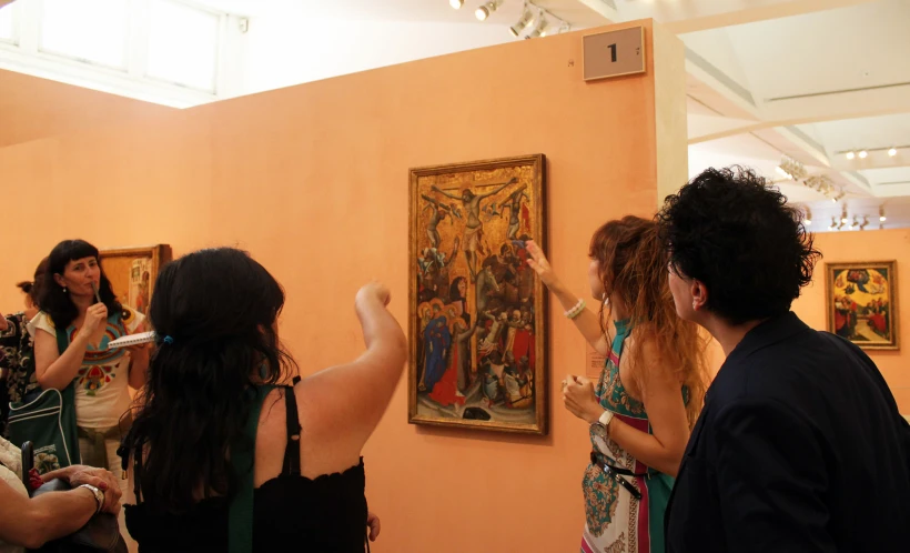 a group of people viewing art on display in a museum