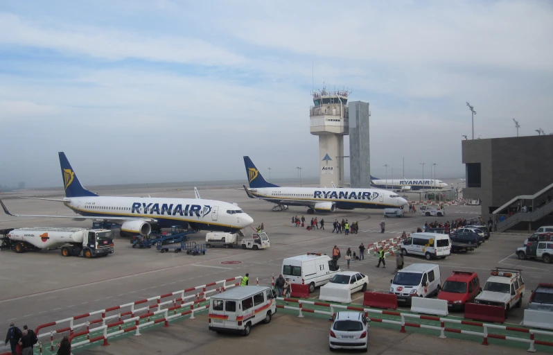 several jumbo jets parked at the airport terminal