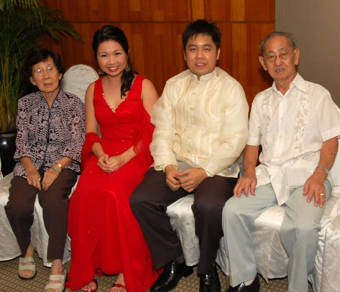 three people wearing matching outfits are sitting on a white bench