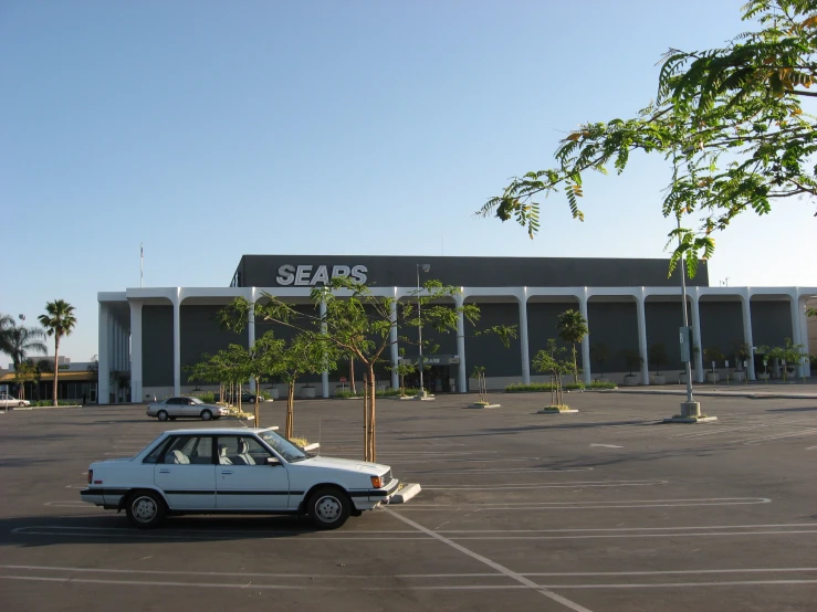 the cars parked in a parking lot have the sign on top of it