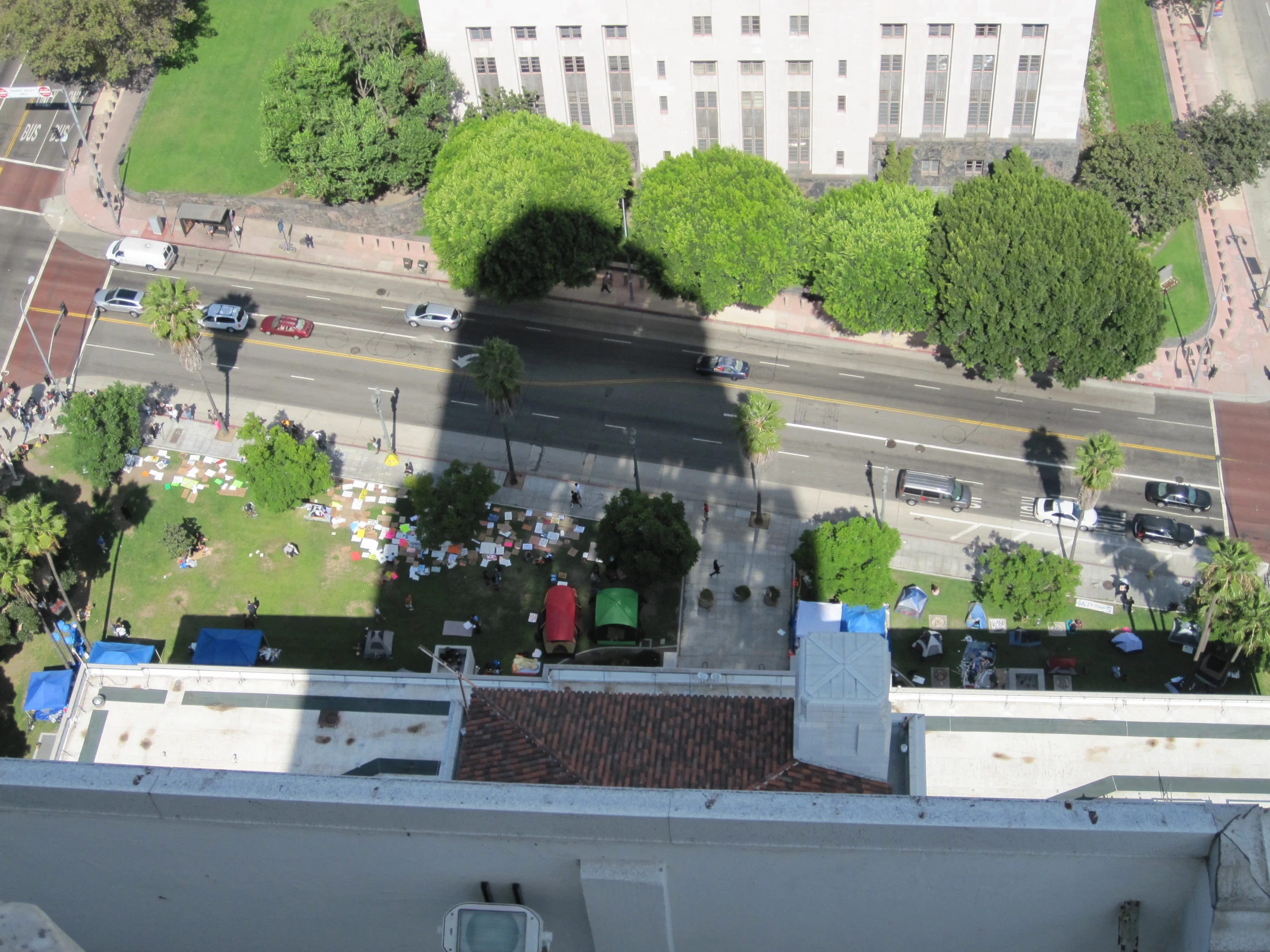 the view of a parking lot and street from the top of a building