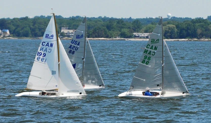 three boats are traveling in the open water