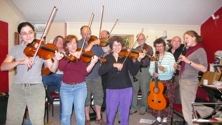 a group of people are holding their instruments together