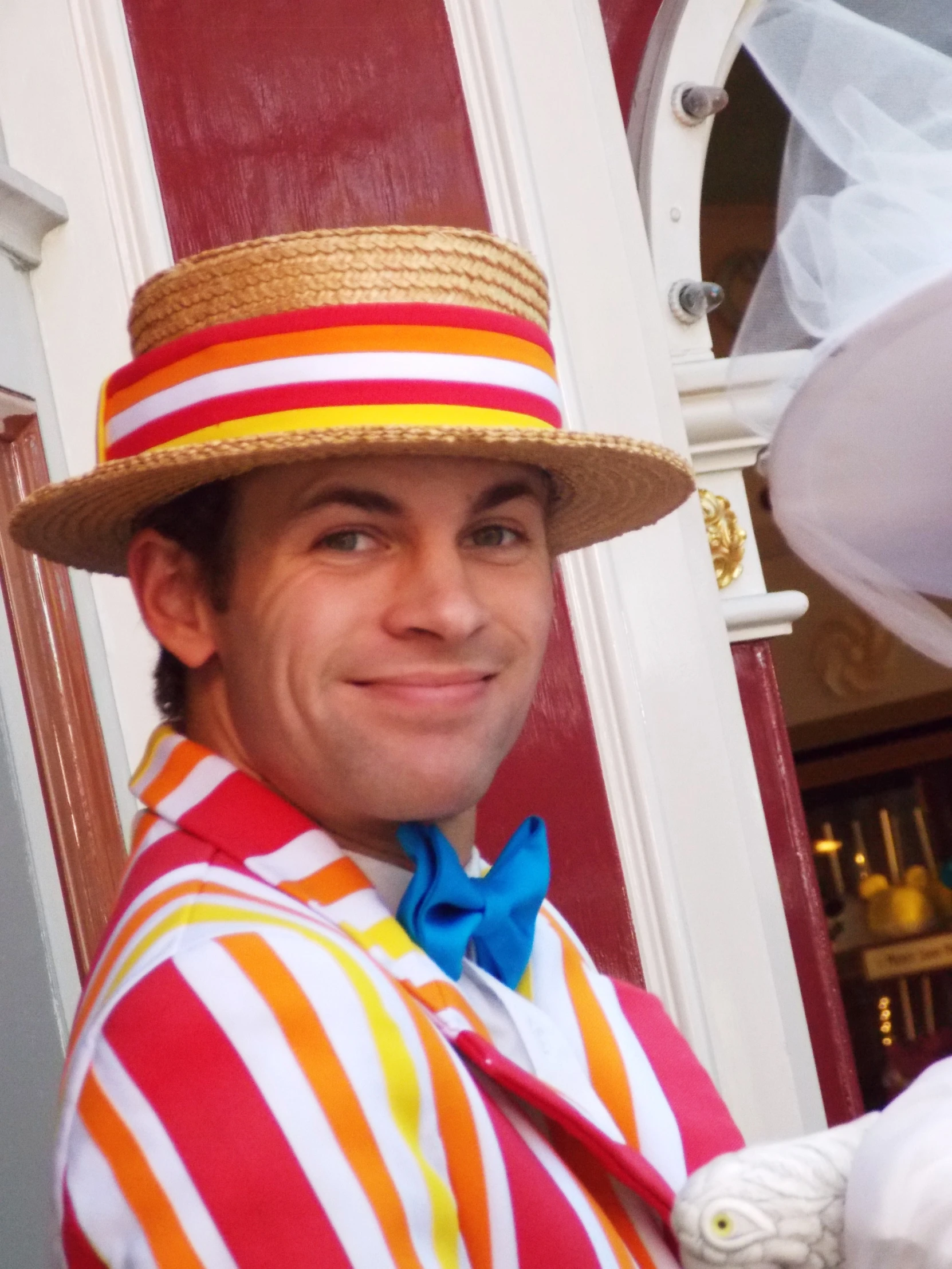 a man in a brightly colored costume poses for a po