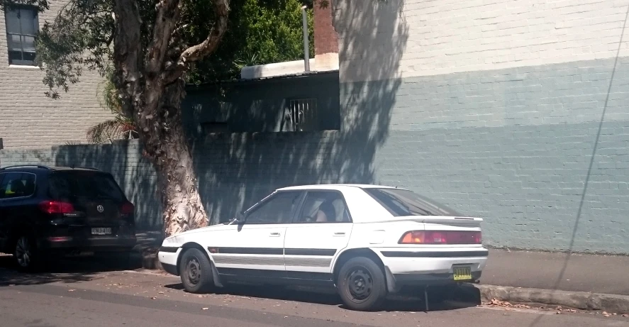 the white car has been parked on the street