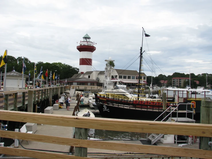 several boats docked in a harbor with a lighthouse