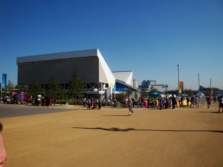 a group of people standing around a large building