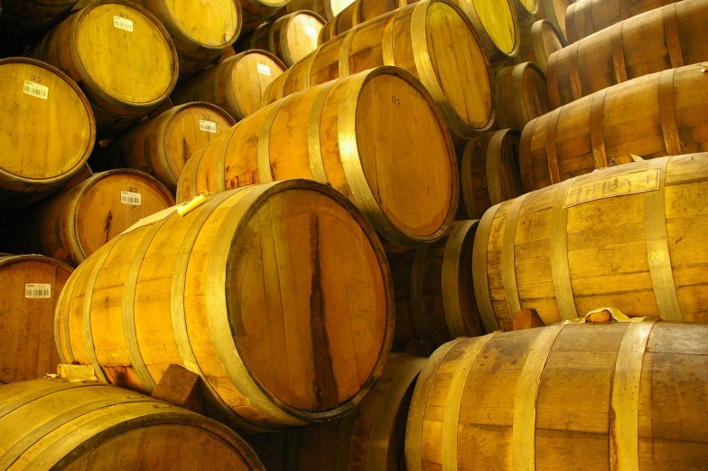 some wooden barrels are stacked together