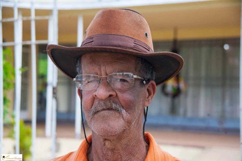 an older man with glasses and a hat