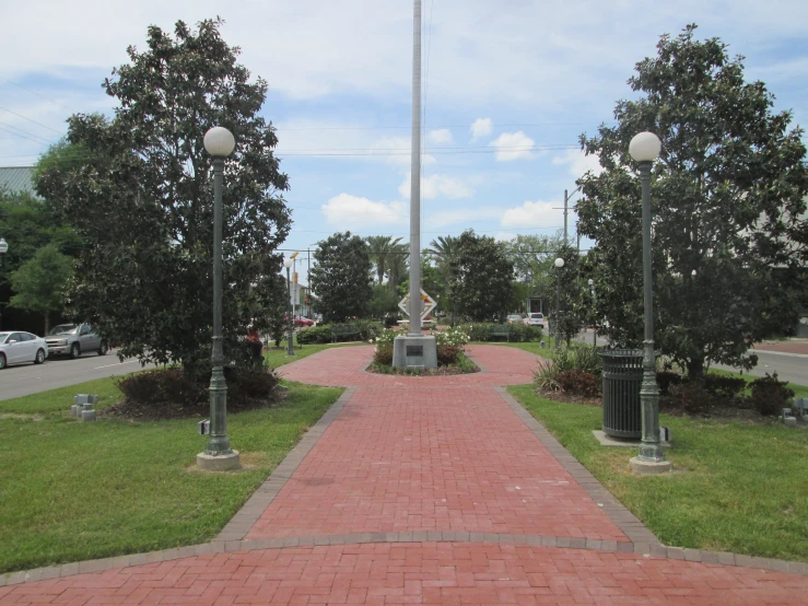 the walkway has benches and lamps along it