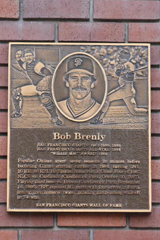 a plaque with an image of a man with a baseball bat