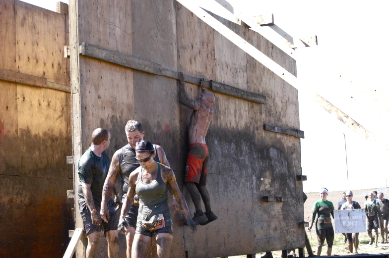 a group of people are standing next to a structure