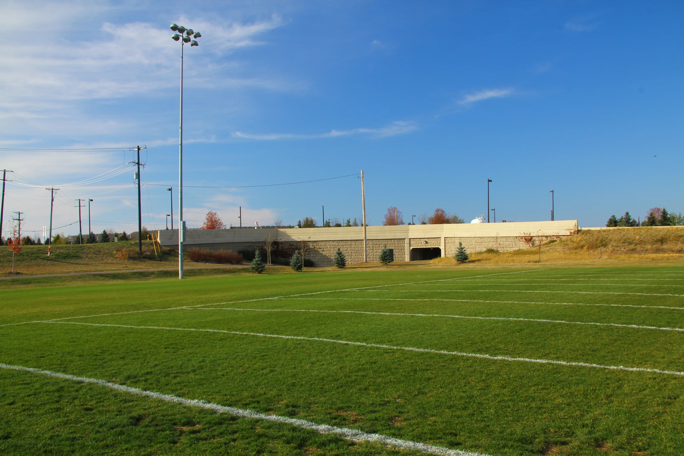 a football field with the goal line and building behind it