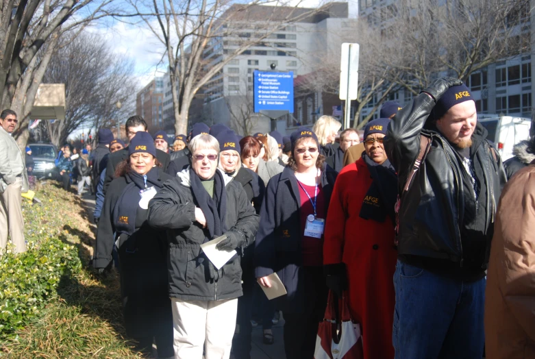 a group of people are standing in front of a bus