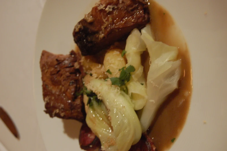 an elaborate plate containing some pasta and meat