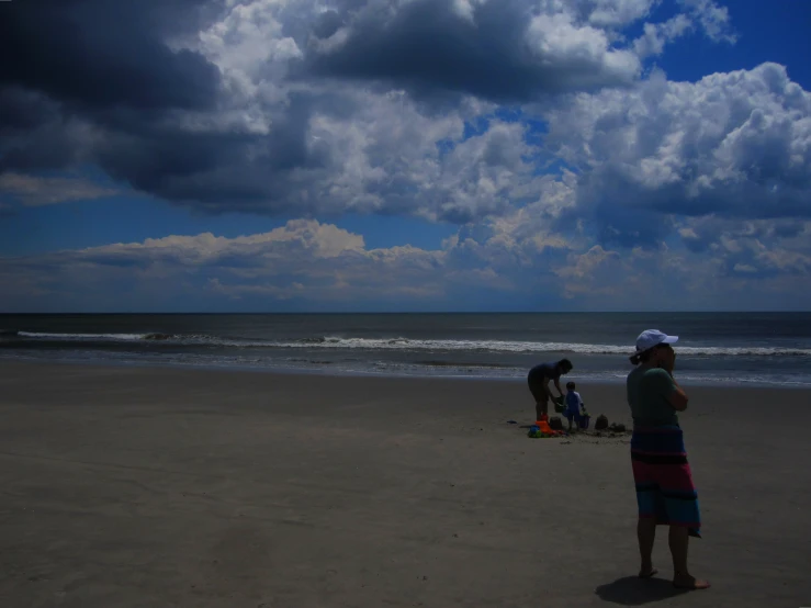 a group of s are on the beach and playing