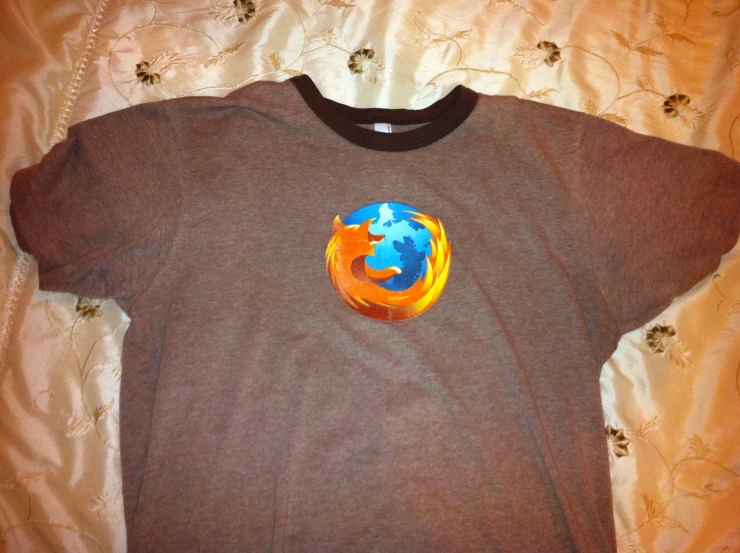 a brown shirt has an orange and blue firefox logo