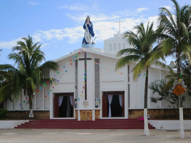 a small church with decorations and people walking around the outside