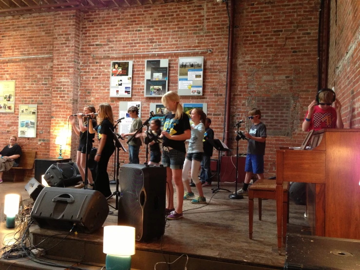 children singing with microphones in the old town theater