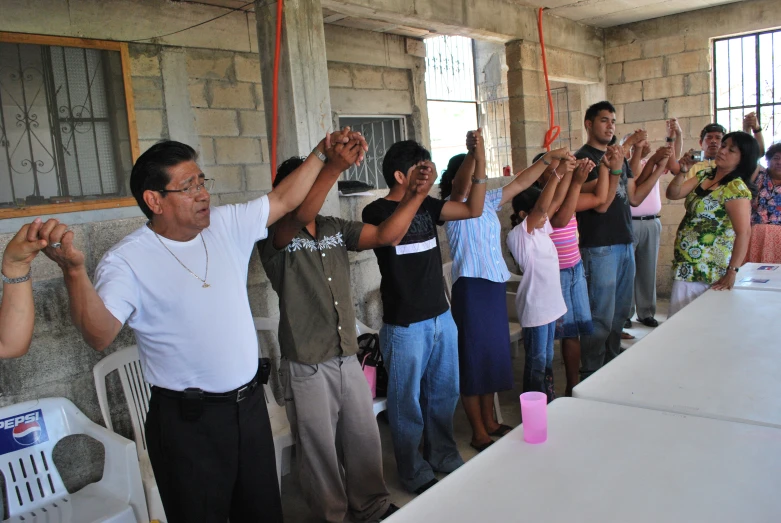 a group of people with their hands up in the air