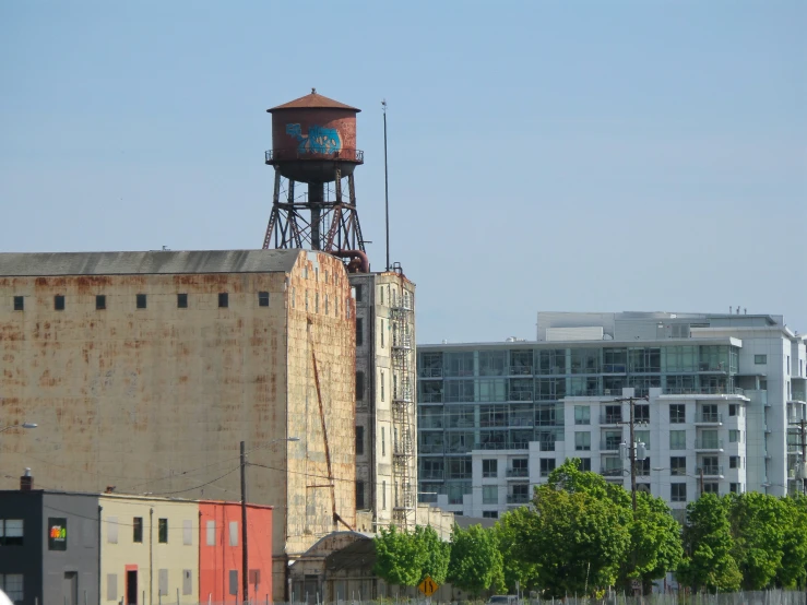 the large building has a water tower behind it