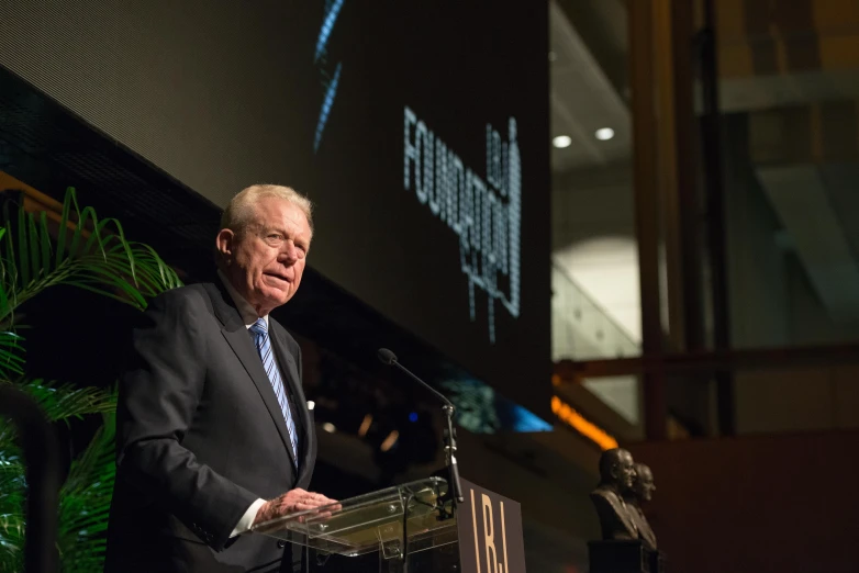 a man giving a speech at a podium