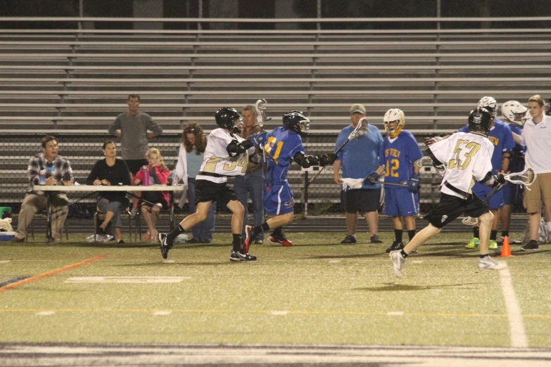 a lacrosse game with a player wearing an athletic uniform