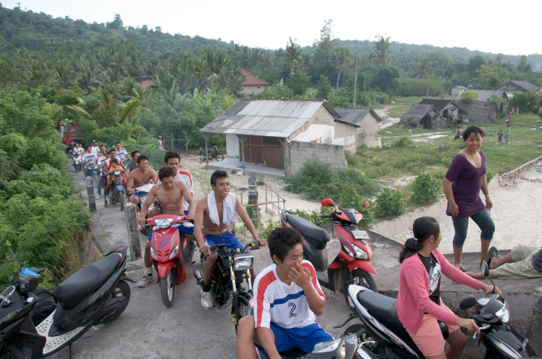 a group of people riding motorcycles with women on bicycles