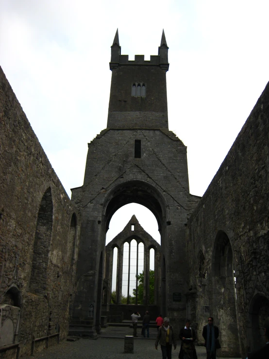 a building with an archway and some people walking outside