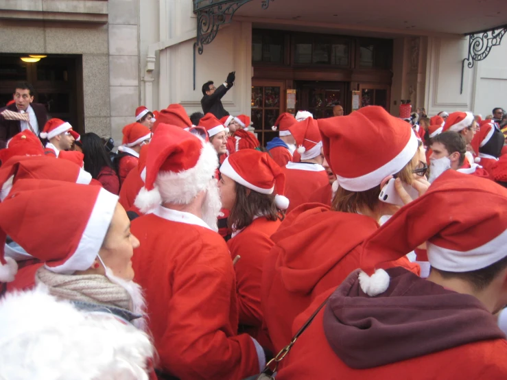 a group of people dressed in santa claus outfits