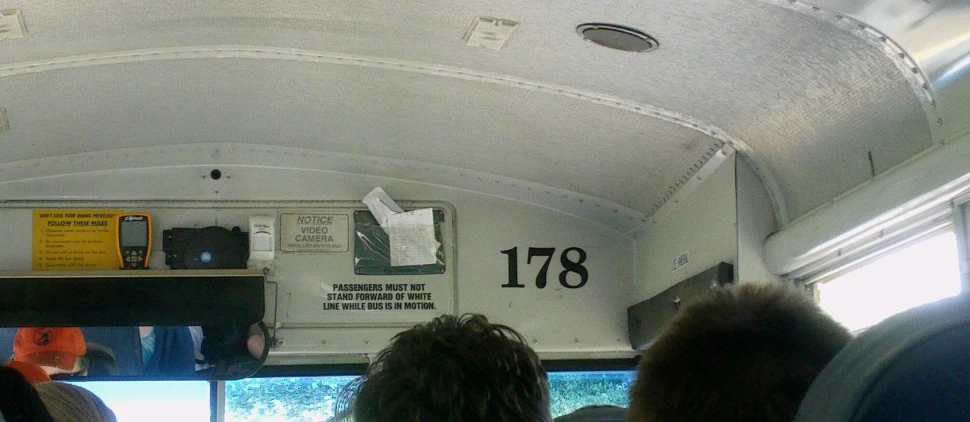 the inside of a bus with people looking in the window