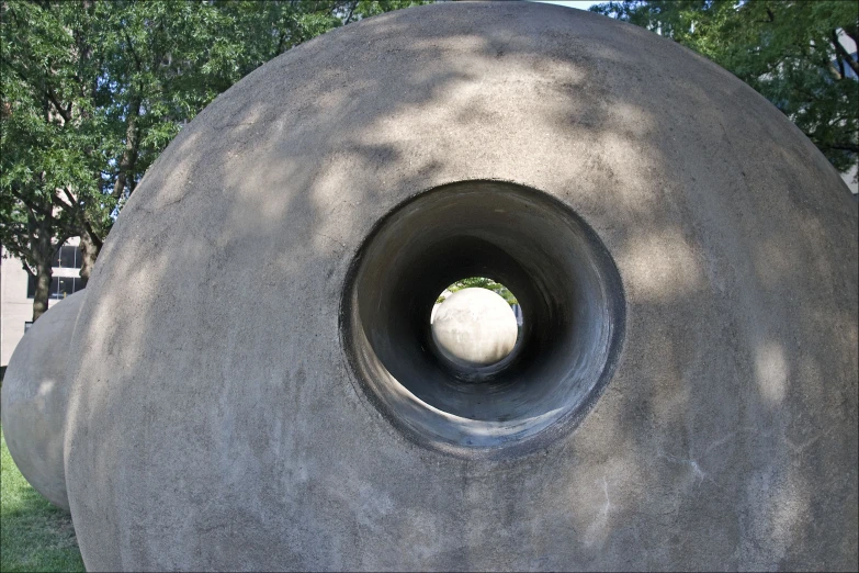 an open cement round hole sits between several other large rocks